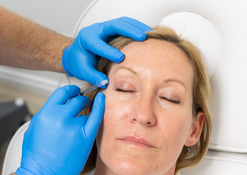 A patient shuts her eyes as she receives Botox for migraines in Thunder Bay, ON.