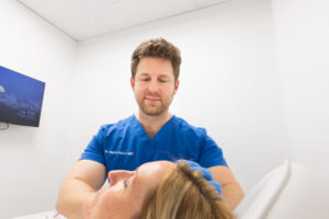 A provider smiles as he performs Botox for migraines in Thunder Bay, ON.