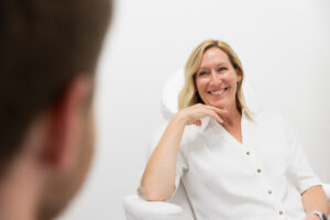 A woman smiles as she learns more about our PRP hair treatment in Thunder Bay, ON.