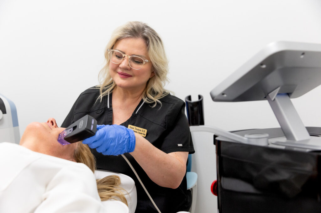 A provider smiles as she applies a treatment with RF microneedling in Thunder Bay, ON.